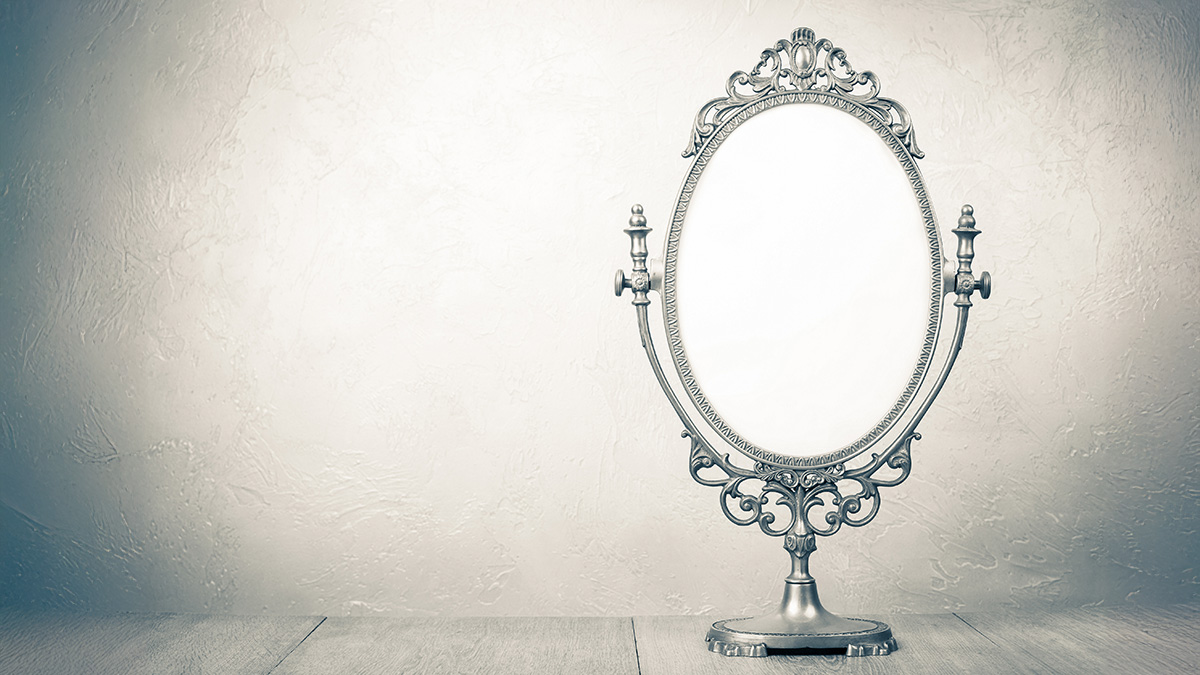 A vintage table mirror on a light background